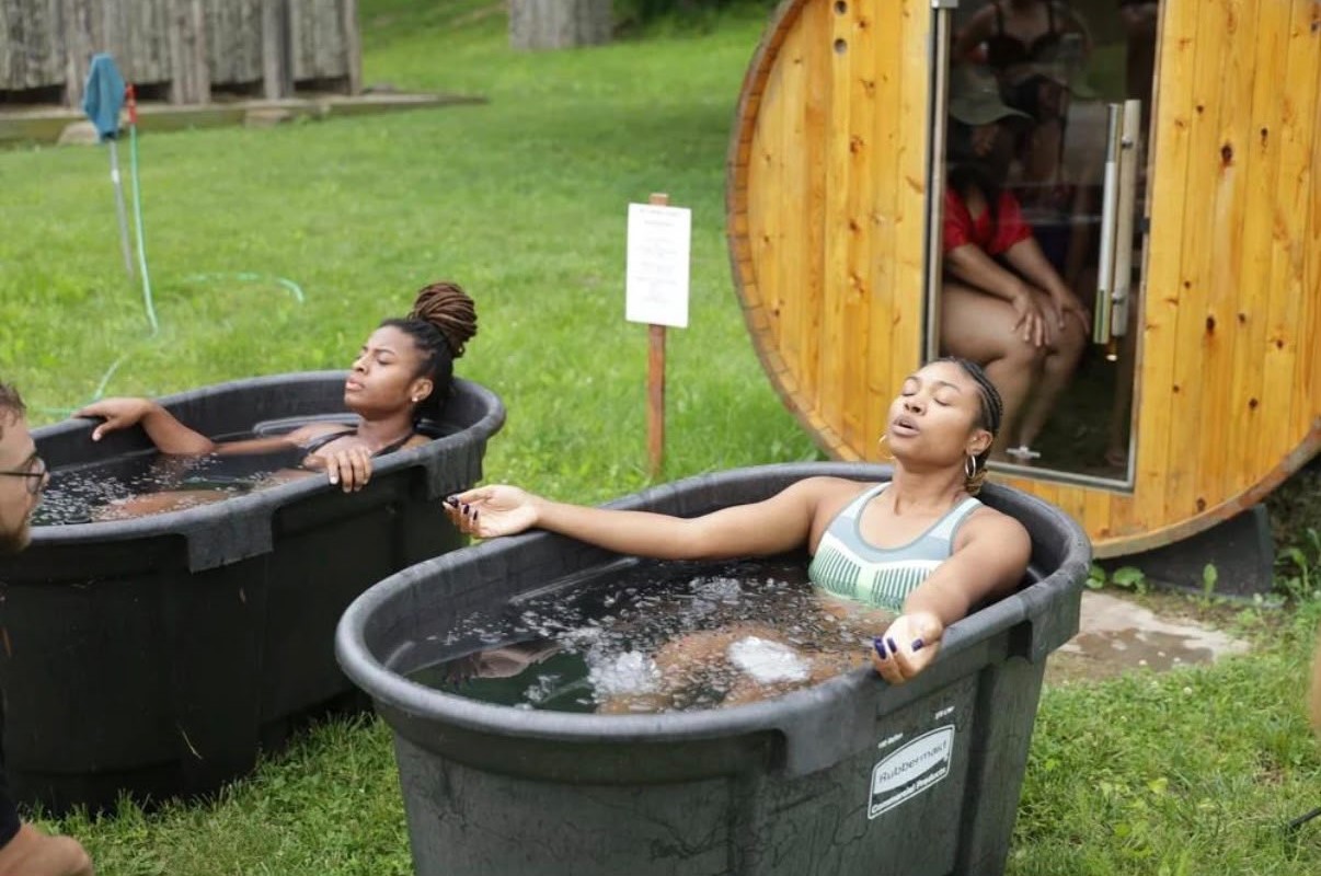 Women in outdoor ice baths practicing calm breath